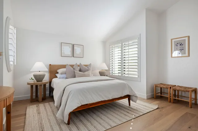 a bedroom with a bed and a chair