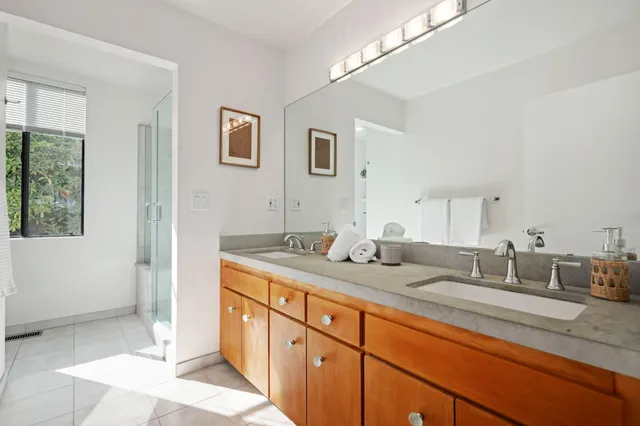 a en suite bathroom with double sink and a mirror