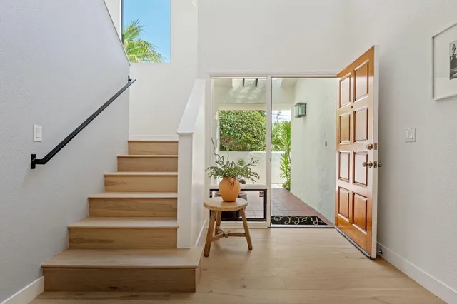 a view of entryway and hall with wooden floor