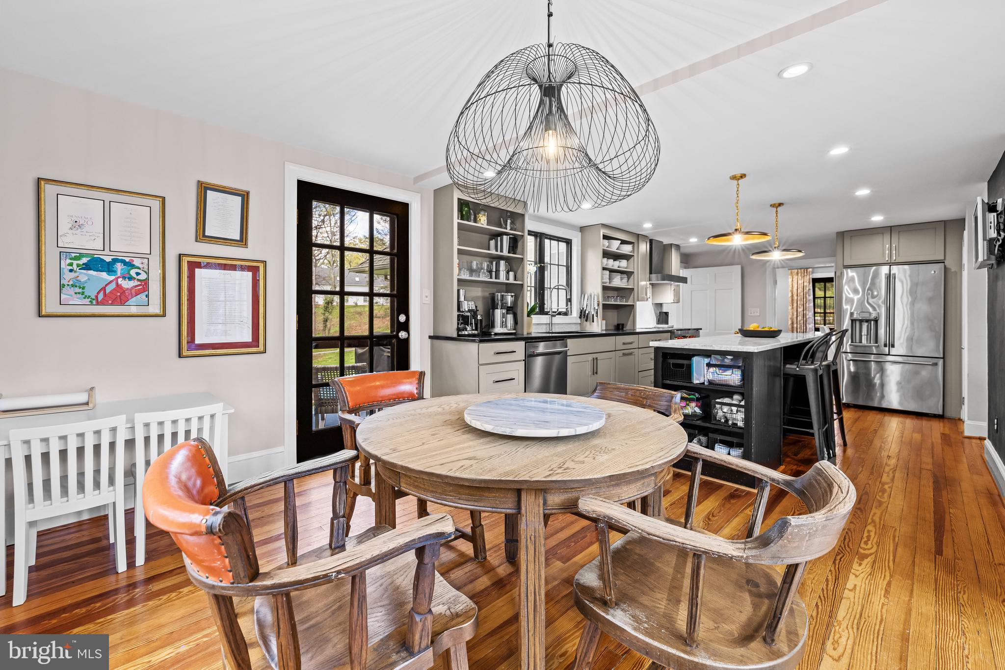 1846 Circle Road Baltimore, MD 21204 - Photo 20 of 62 a dining room with wooden floor a chandelier a wooden table and chairs