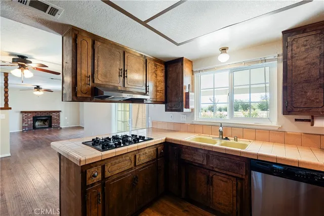 a kitchen with stainless steel appliances granite countertop a sink stove and cabinets