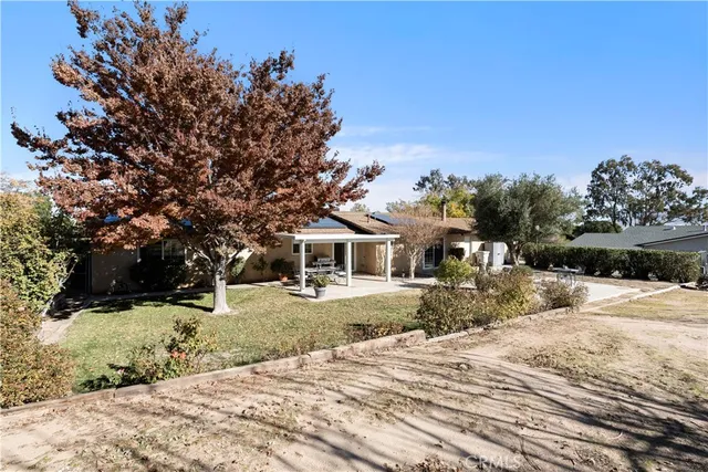 a front view of a house with a yard covered in snow