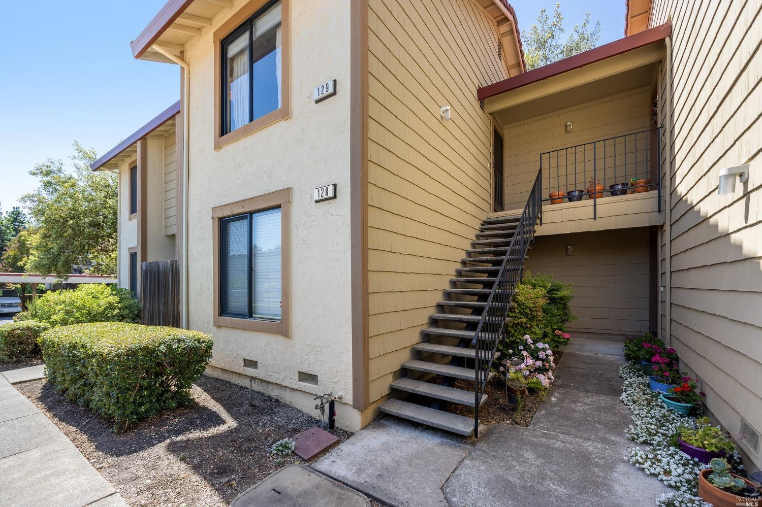 a backyard of a house with plants and outdoor seating