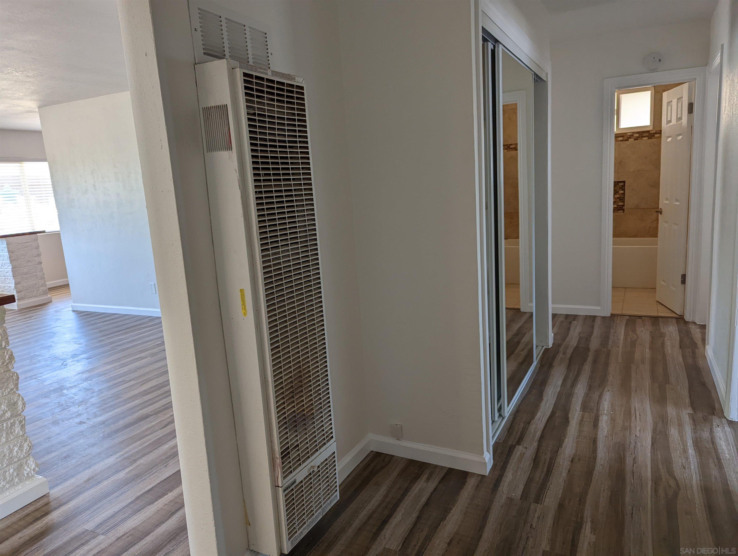 1207 Lyons Lane El Cajon, CA 92021 - Photo 22 of 39 a view of hallway with wooden floor