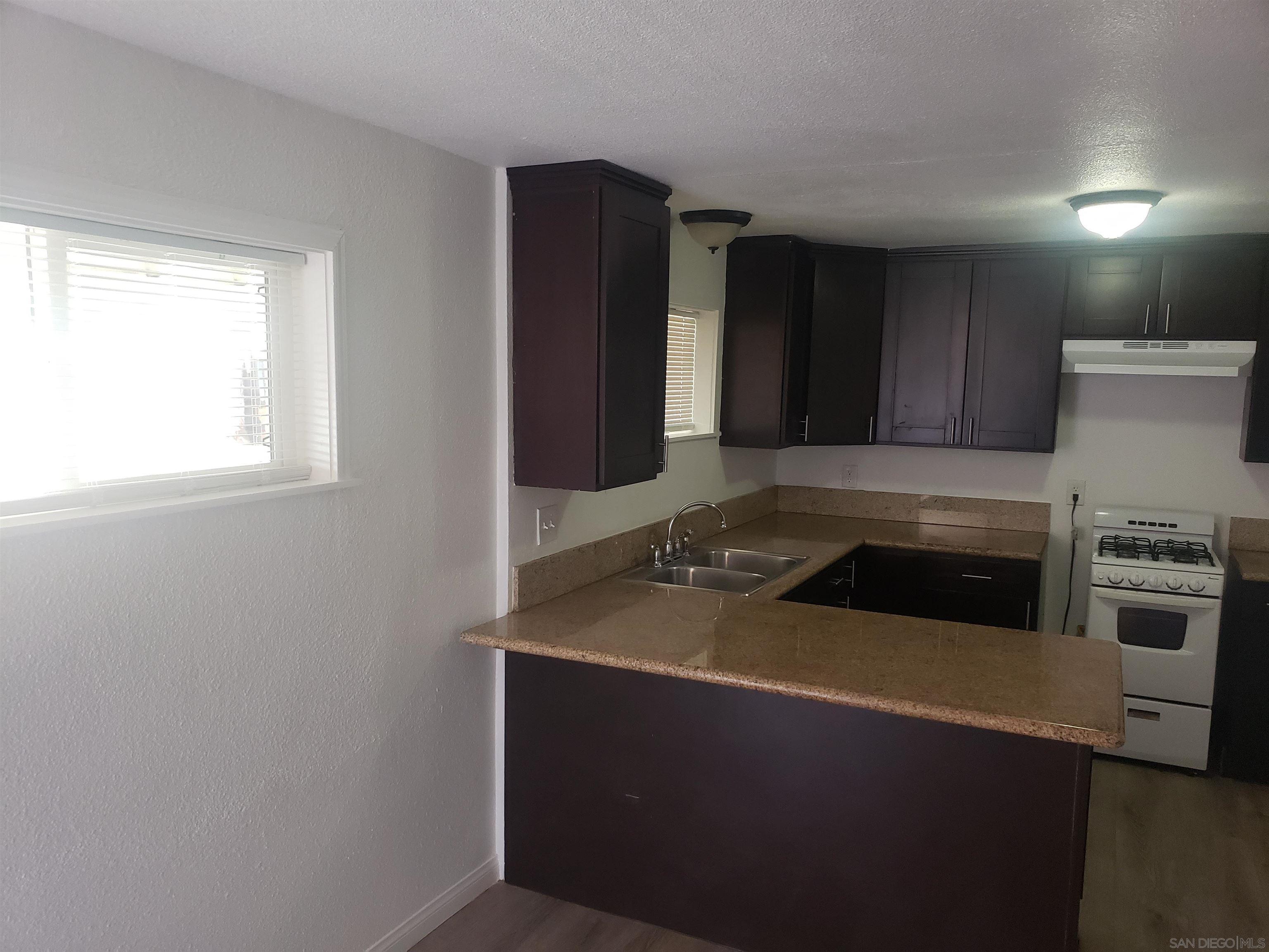 1207 Lyons Lane El Cajon, CA 92021 - Photo 28 of 39 a kitchen with granite countertop cabinets and steel stainless steel appliances