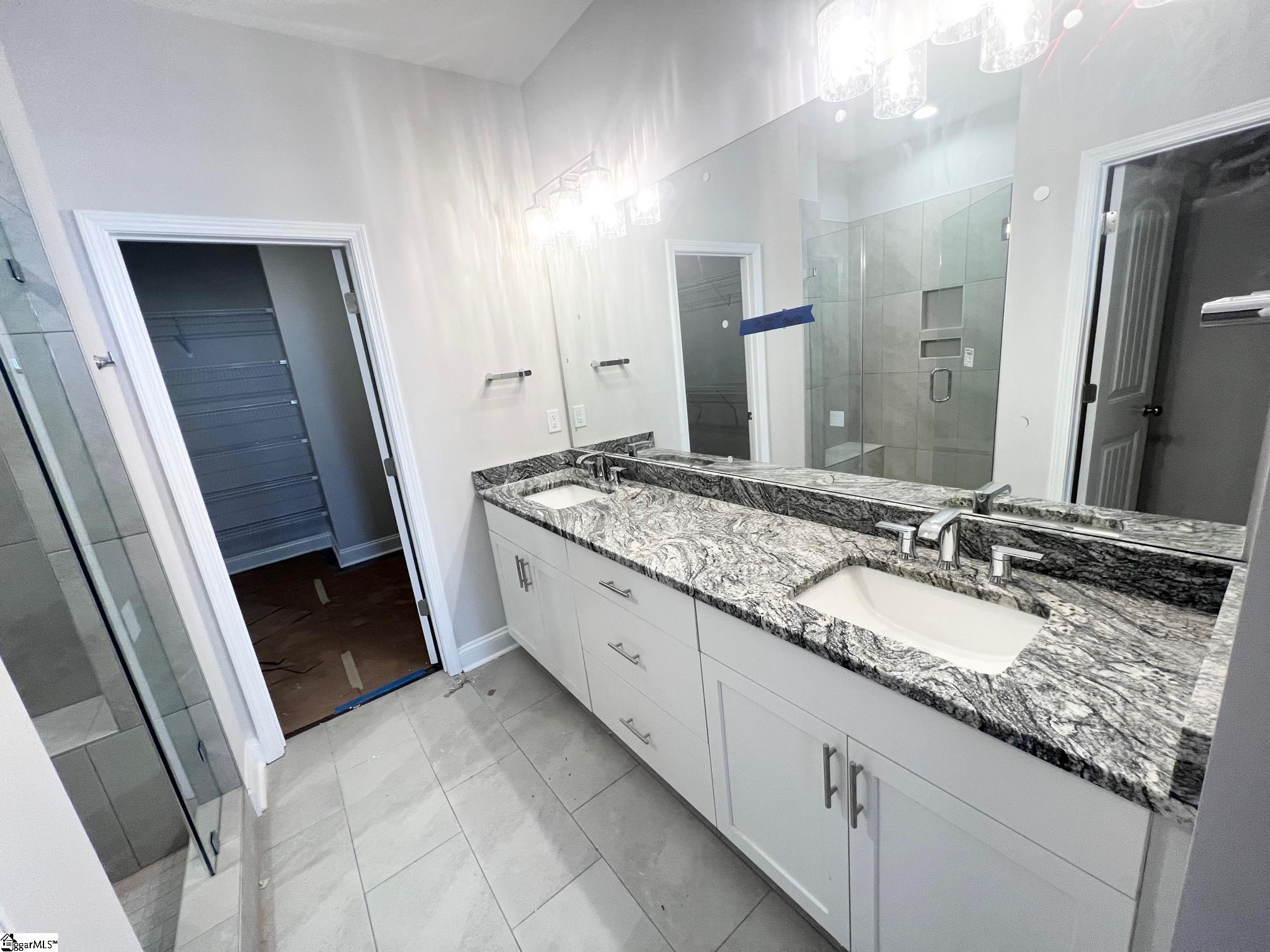 135 Green Heron Road Greenville, SC 29607 - Photo 12 of 26 Double vanities, upgraded plumbing fixtures, level 3 tile flooring, frameless shower door.