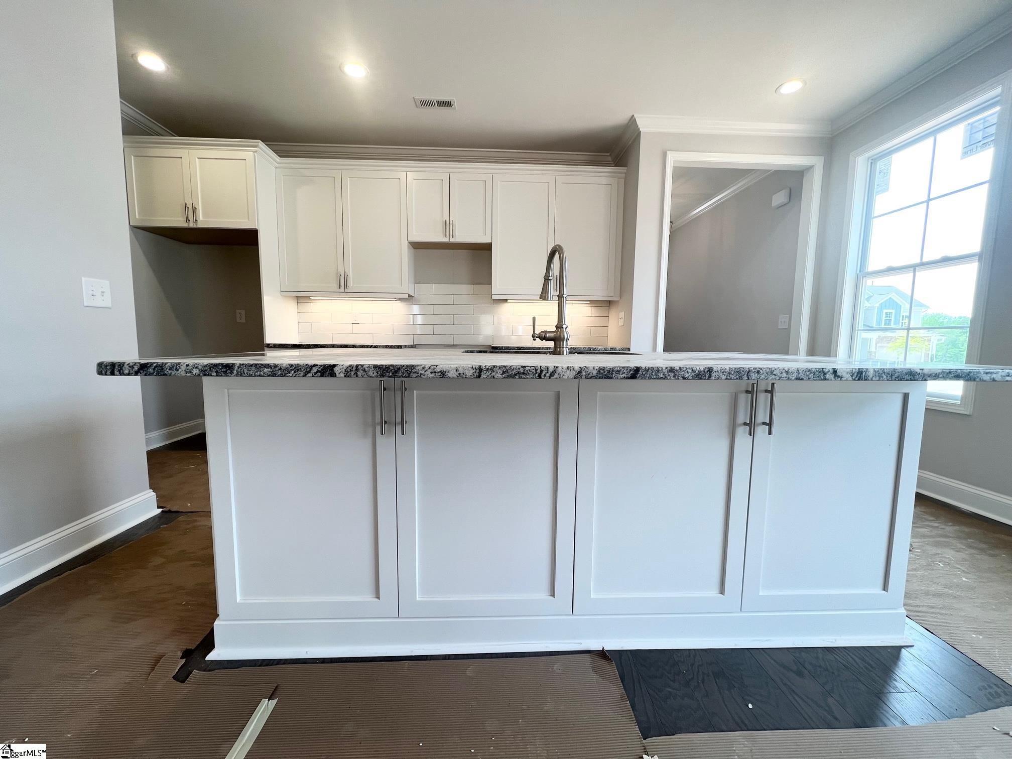 135 Green Heron Road Greenville, SC 29607 - Photo 4 of 26 Upgraded kitchen island with additional cabinets and countertop space! Great for entertaining