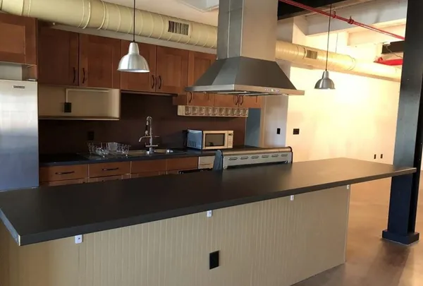 a kitchen with stainless steel appliances granite countertop a sink a stove and a microwave