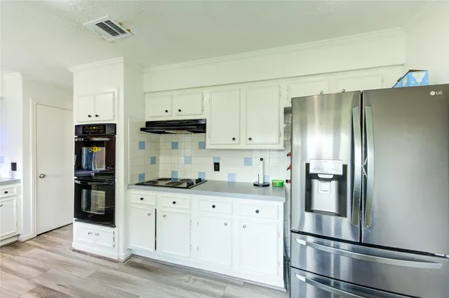 a kitchen that has a sink and a stove in it