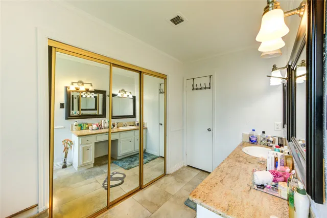 a bathroom with a granite countertop sink a mirror and a window