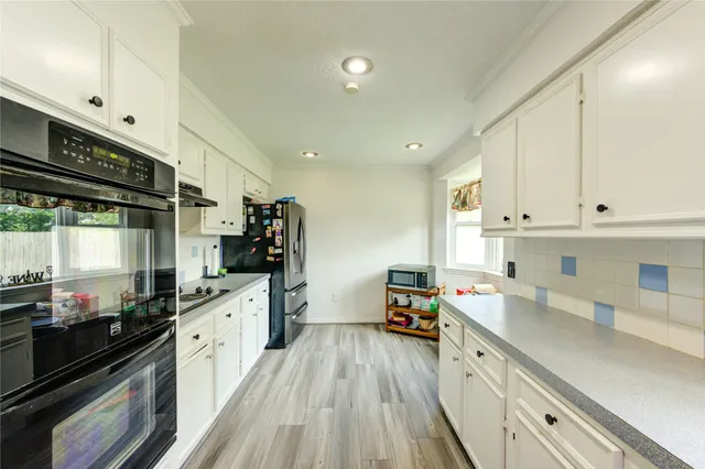 a room with furniture and view of kitchen