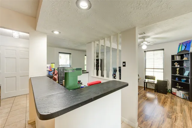a living room with kitchen island furniture and a wooden floor