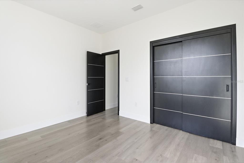 13250 Southwest 79th Circle Ocala, FL 34473 - Photo 29 of 44 a view of an empty room with closet and wooden floor