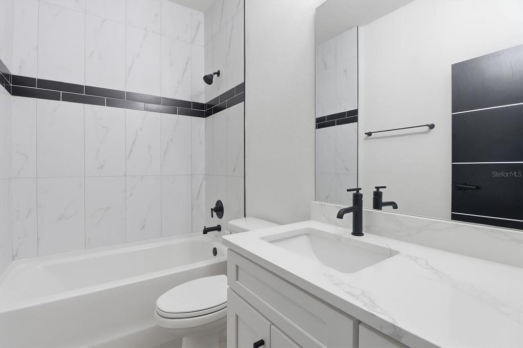 13250 Southwest 79th Circle Ocala, FL 34473 - Photo 34 of 44 a bathroom with a sink toilet a mirror and shower