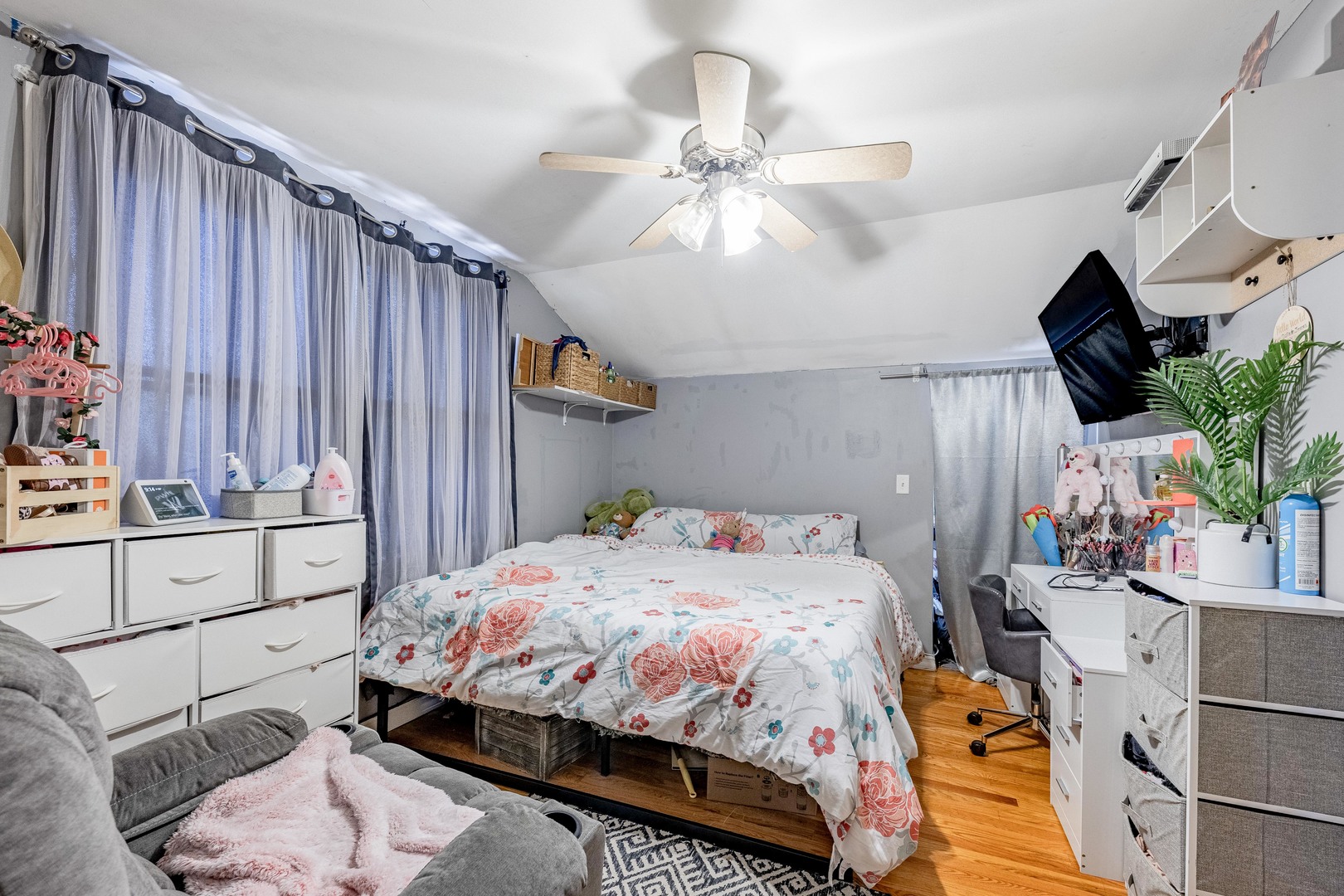 5844 West Maple Avenue Berkeley, IL 60163 - Photo 20 of 46 a bedroom with a bed a dresser and potted plants