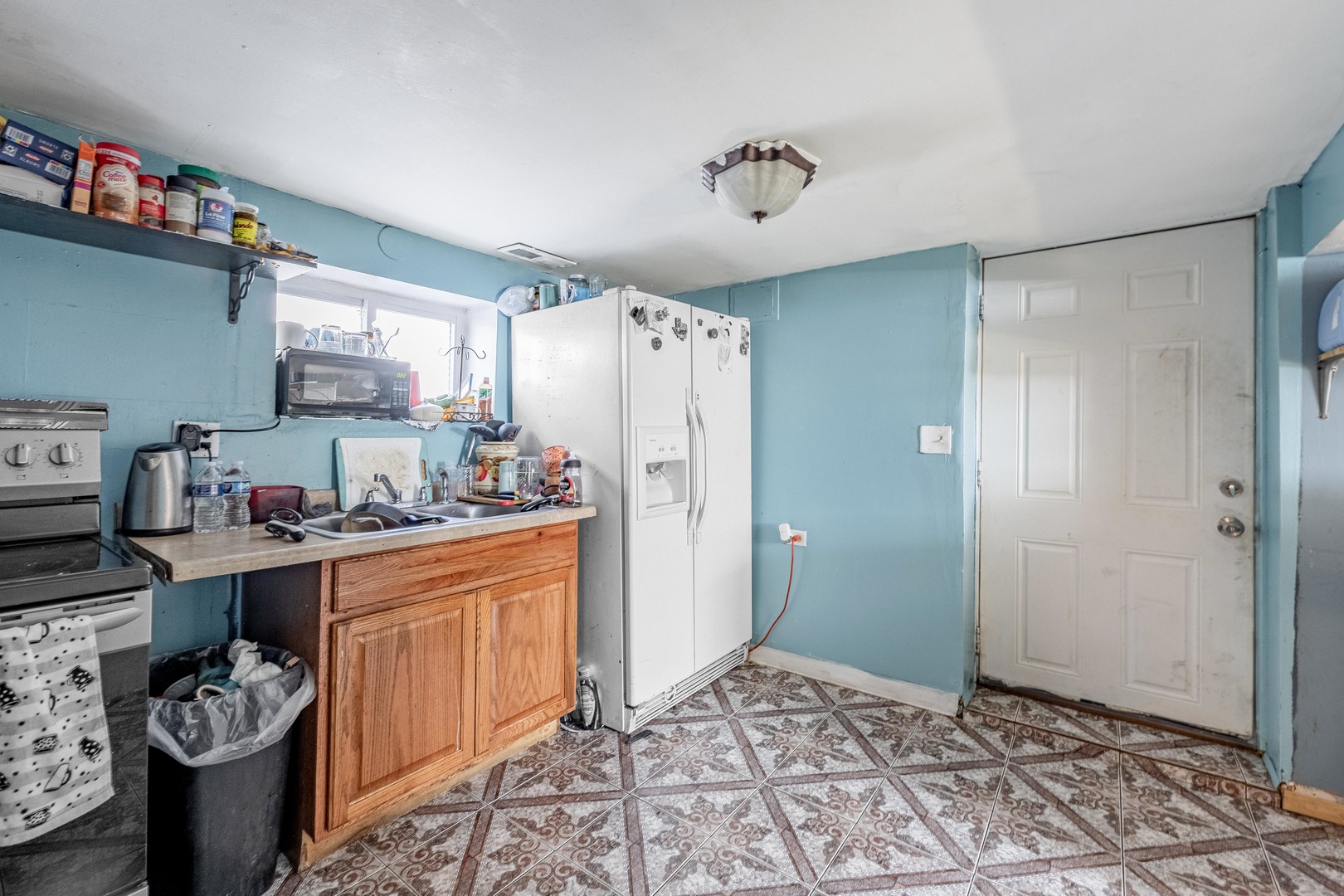 5844 West Maple Avenue Berkeley, IL 60163 - Photo 29 of 46 a kitchen with stainless steel appliances granite countertop a refrigerator and a stove top oven