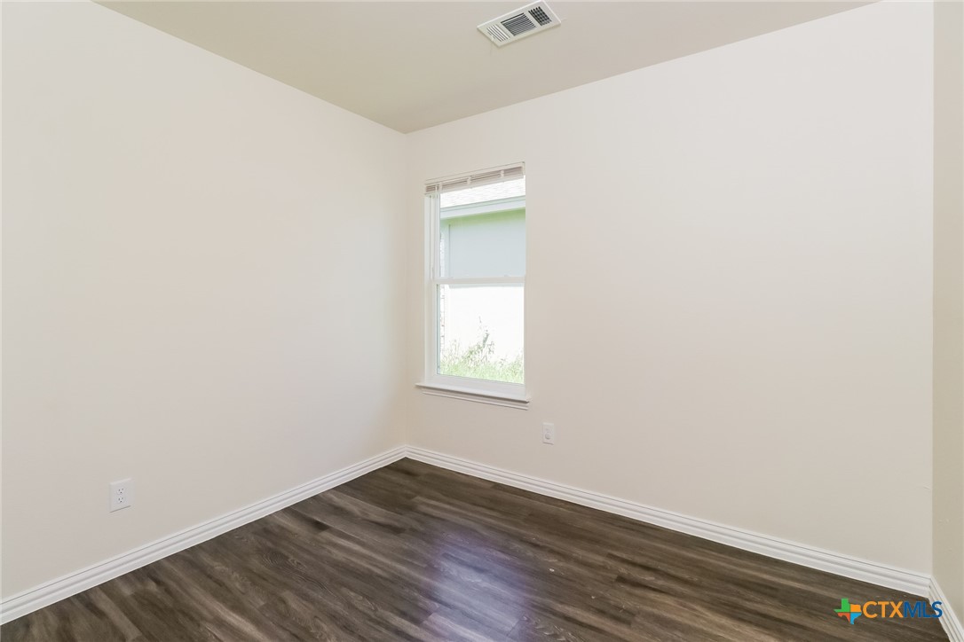505 South 16th Street Temple, TX 76501 - Photo 17 of 21 a view of an empty room with wooden floor and a window