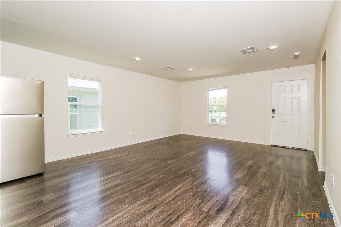 505 South 16th Street Temple, TX 76501 - Photo 5 of 21 a view of an empty room with wooden floor and a window