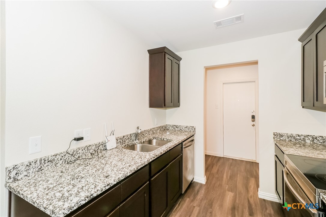 505 South 16th Street Temple, TX 76501 - Photo 7 of 21 a kitchen with a sink stove and cabinets