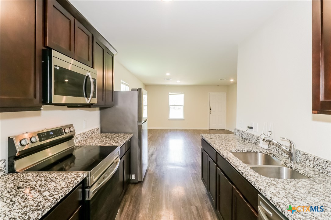 505 South 16th Street Temple, TX 76501 - Photo 8 of 21 a kitchen with stainless steel appliances granite countertop a sink stove and refrigerator