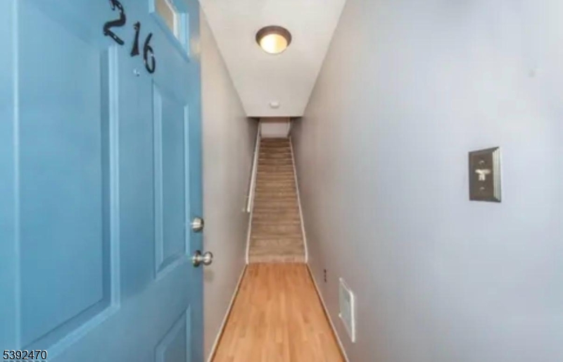 216 Woods Edge Drive Succasunna, NJ 07876 - Photo 2 of 13 a view of a hallway with wooden floor and entryway