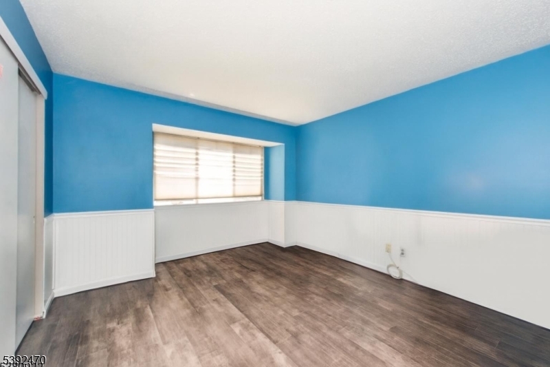 216 Woods Edge Drive Succasunna, NJ 07876 - Photo 3 of 13 a view of an empty room with wooden floor and a window