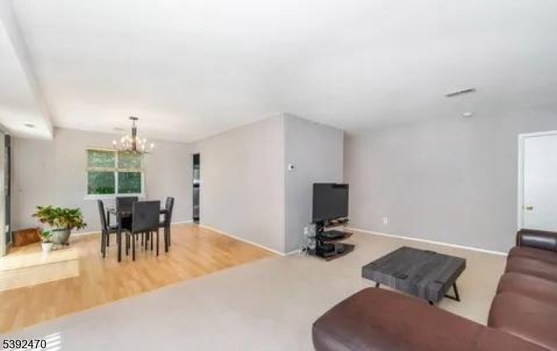 216 Woods Edge Drive Succasunna, NJ 07876 - Photo 4 of 13 a living room with furniture and a chandelier