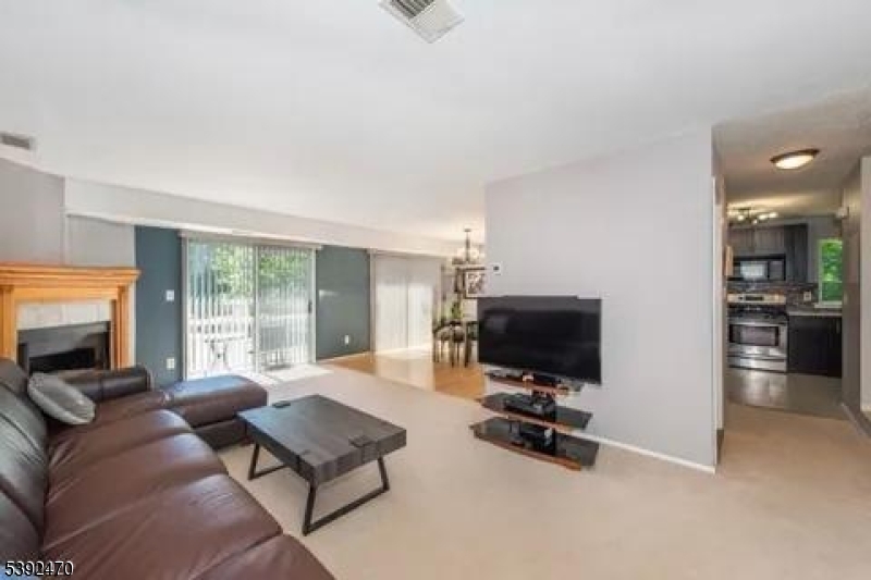 216 Woods Edge Drive Succasunna, NJ 07876 - Photo 6 of 13 a living room with furniture and a flat screen tv