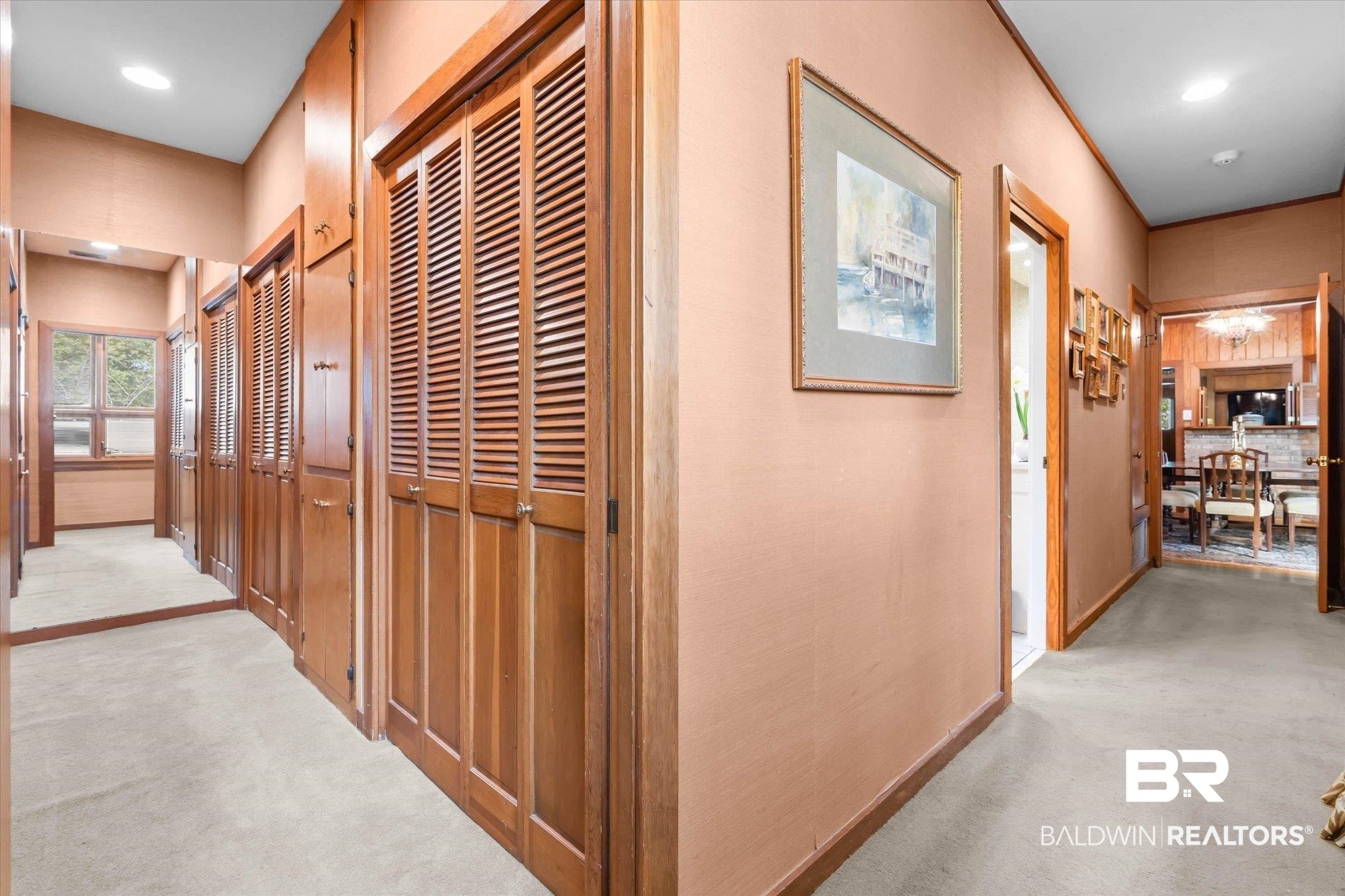 3500 Venetia Road Mobile, AL 36605 - Photo 18 of 56 Hallway featuring extensive wood-finish louvered bi-fold doors, wood-finish trim, and recessed lighting