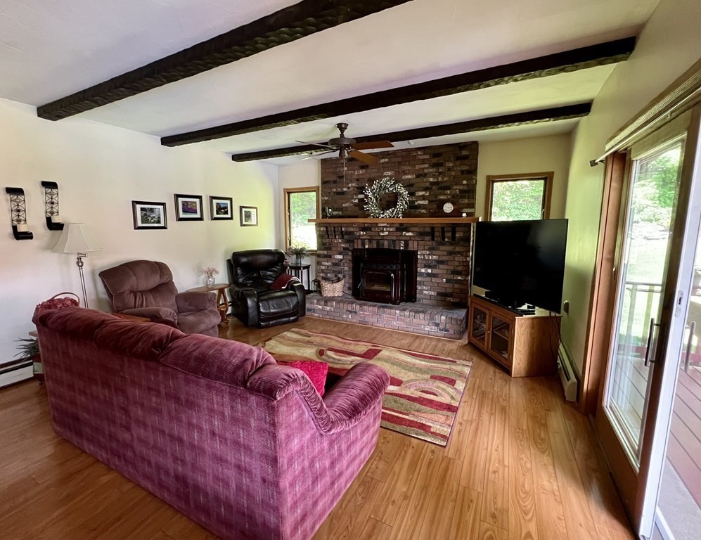 22 Franklin Road Gill, MA 01354 - Photo 7 of 28 a living room with furniture wooden floor and a fireplace