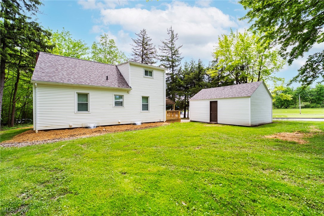 708 South Meridian Road Youngstown, OH 44515 - Photo 9 of 43 Rear view of house featuring a lawn, roof with shingles, and a wooden deck