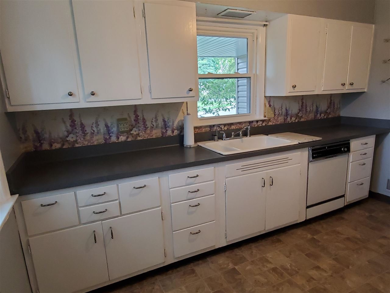 1527 Rural Street Rockford, IL 61107 - Photo 4 of 13 a kitchen with white cabinets and white appliances