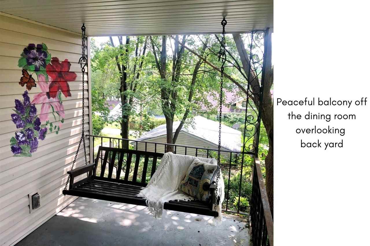 1527 Rural Street Rockford, IL 61107 - Photo 9 of 13 a view of a porch with a table and chairs and floor to ceiling window