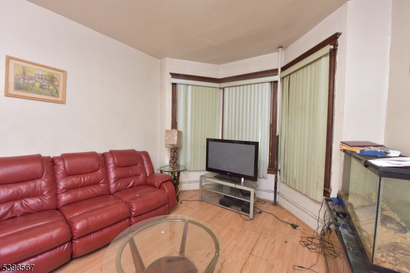 240 Clinton Avenue Jersey City, NJ 07304 - Photo 3 of 14 a living room with furniture a flat screen tv and a window