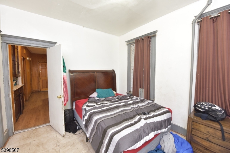 240 Clinton Avenue Jersey City, NJ 07304 - Photo 5 of 14 a bedroom with a bed and a dresser