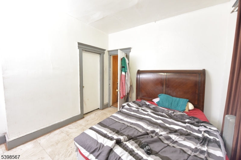 240 Clinton Avenue Jersey City, NJ 07304 - Photo 6 of 14 a bedroom with a bed and a mirror