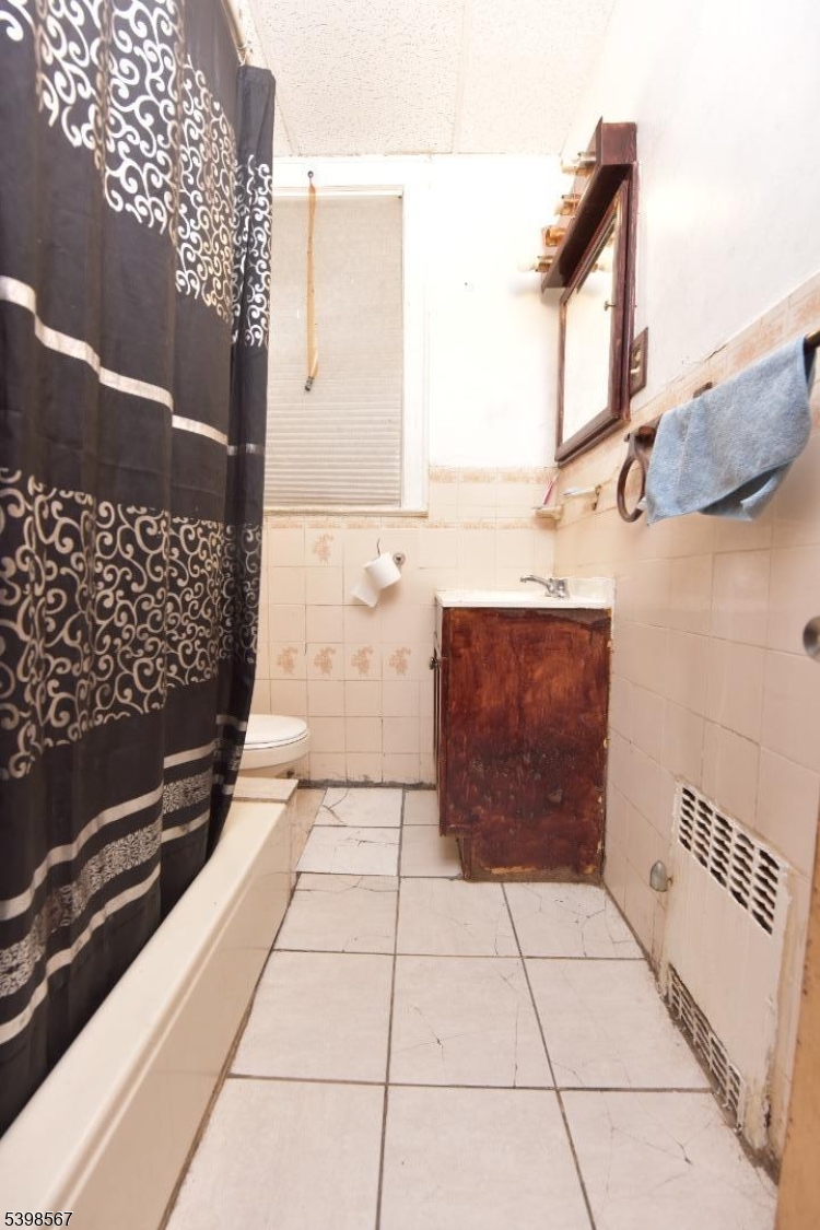 240 Clinton Avenue Jersey City, NJ 07304 - Photo 7 of 14 a bathroom with a bathtub and a shower
