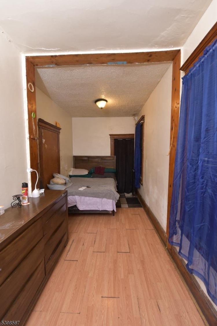 240 Clinton Avenue Jersey City, NJ 07304 - Photo 9 of 14 a view of a room with wooden floor and furniture