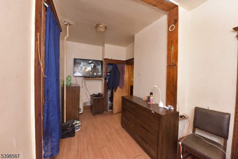 240 Clinton Avenue Jersey City, NJ 07304 - Photo 10 of 14 a living room with furniture and a flat screen tv
