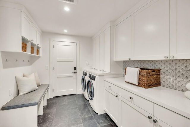 a kitchen with white cabinets and white appliances