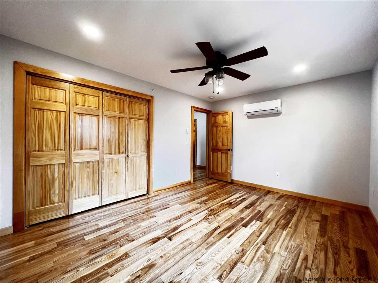 133 Rockefeller Lk Road Cairo, NY 12413 - Photo 22 of 35 a view of empty room with wooden floor and fan