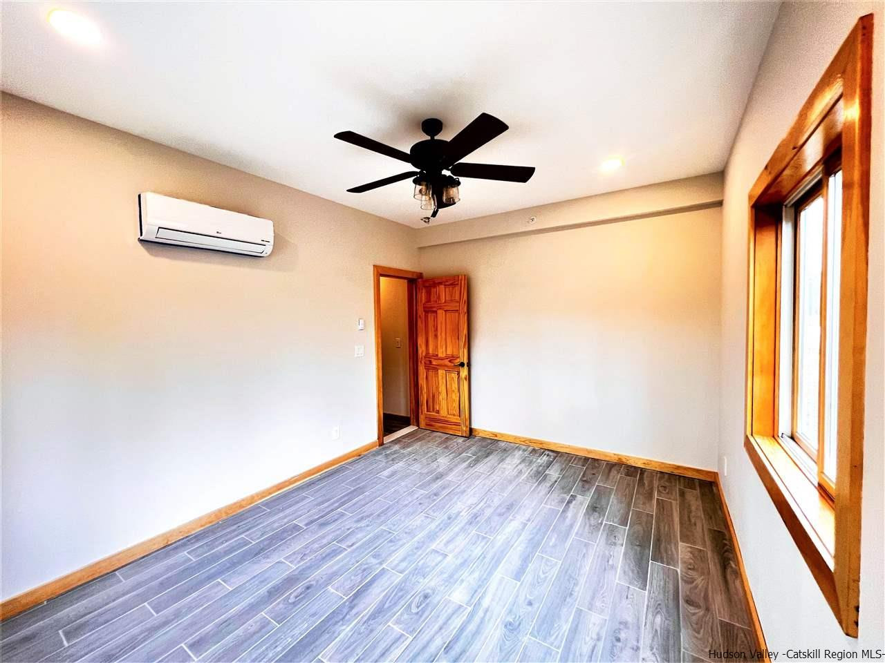133 Rockefeller Lk Road Cairo, NY 12413 - Photo 31 of 35 a view of empty room with wooden floor and fan