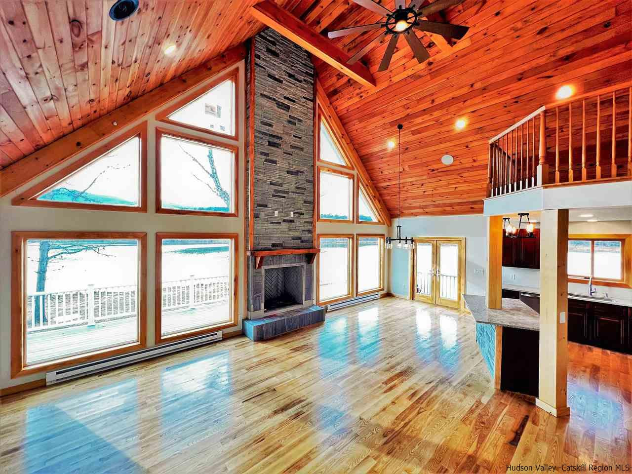 133 Rockefeller Lk Road Cairo, NY 12413 - Photo 4 of 35 an empty room with wooden floor and windows