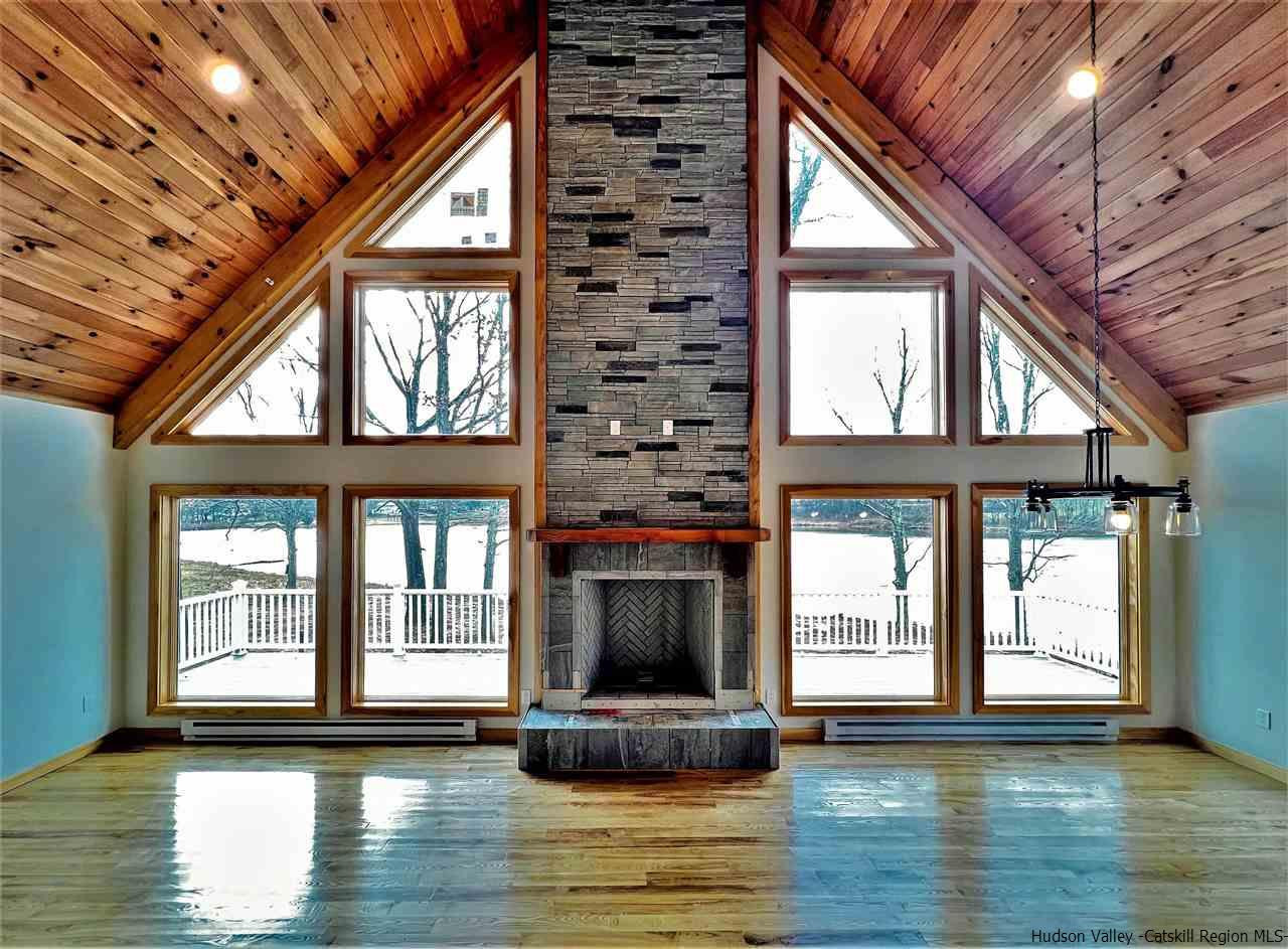 133 Rockefeller Lk Road Cairo, NY 12413 - Photo 6 of 35 a view of a room with wooden floor and a window
