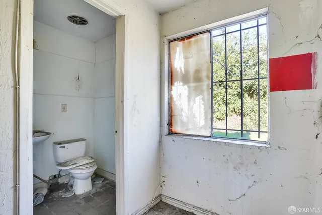 a bathroom with a toilet sink and a shower