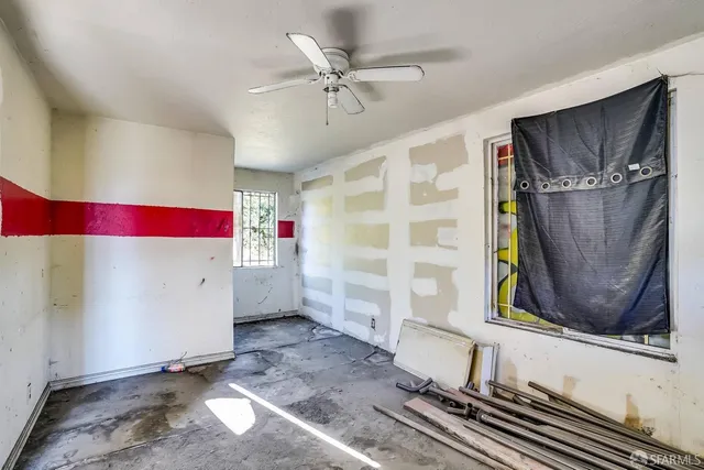 a room with a wooden floor and white walls