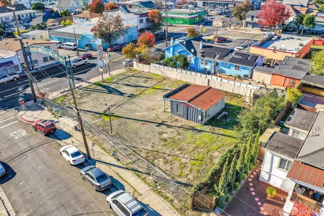 an aerial view of a houses with swimming pool