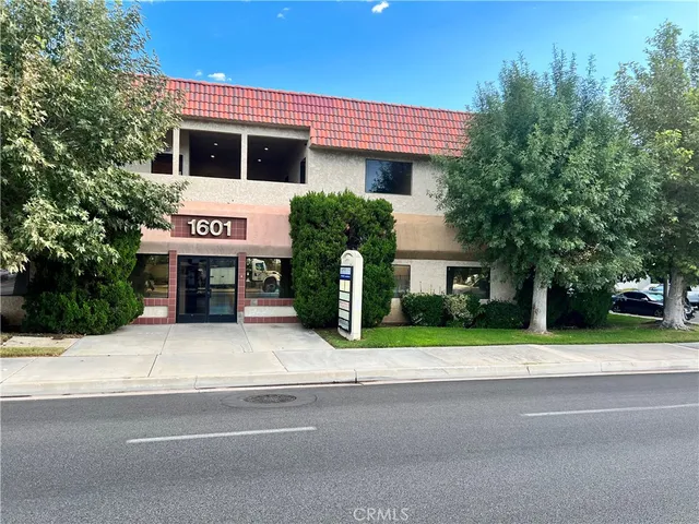 a house with sign board and a yard