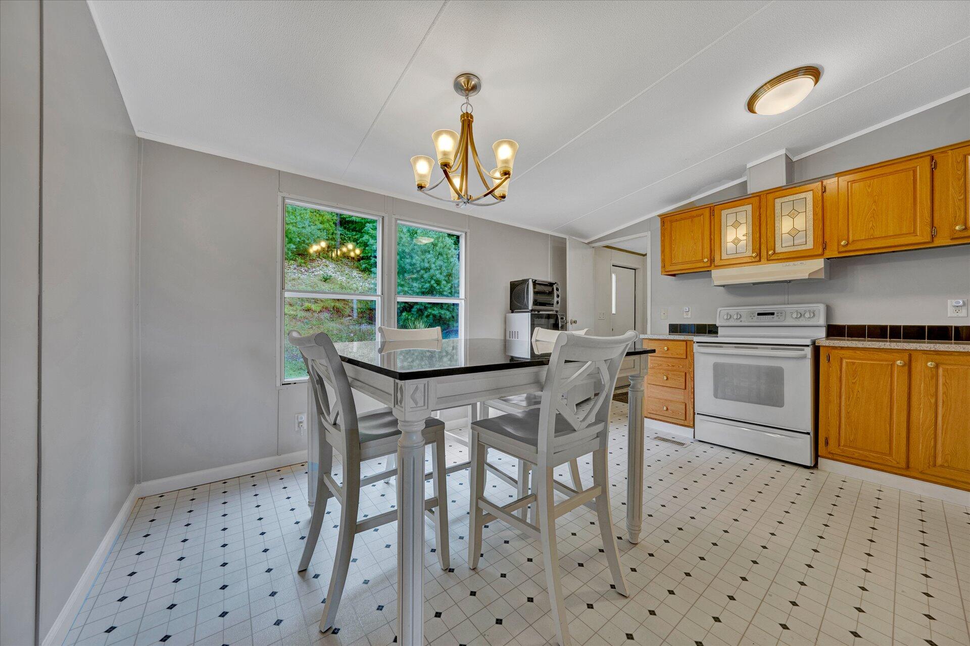 4120 Sunflower Road Pilot, VA 24138 - Photo 10 of 35 a dining room with furniture a window and stainless steel appliances
