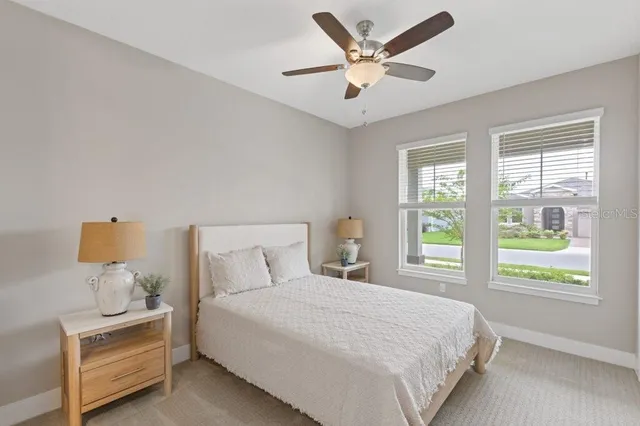 a bedroom with a bed and a large window